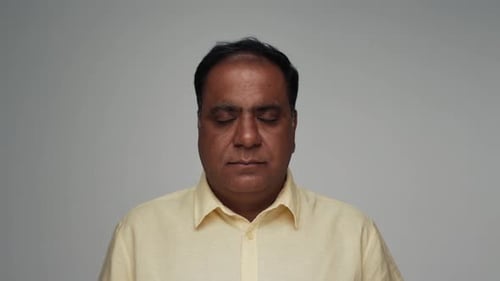 Portrait of Old Indian Man As Adult Model Opening Eyes and Looking at Camera