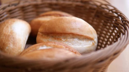 Delectable Freshly Baked Rolls Presented in a Charming Wicker Basket for Enjoyment