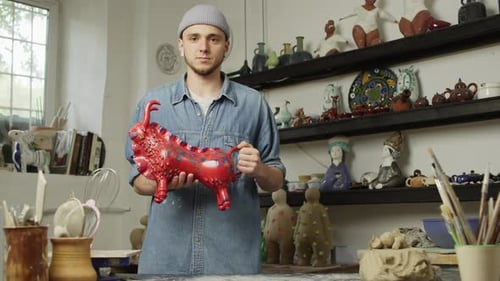 Portrait of a Caucasian Gongchar Holding a Ceramic Product in His Hands