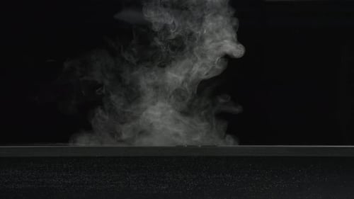 Slow motion dry ice fog/vapor floating on surface of water and bubbling in water. For use with visua