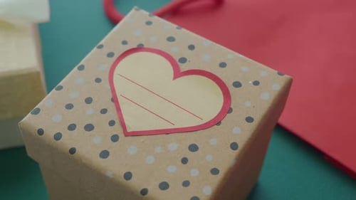 Gift Packaging with Heart Decoration on a Table