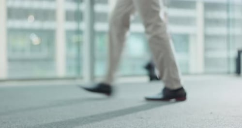 Legs, floor and walking with business people in the office for corporate