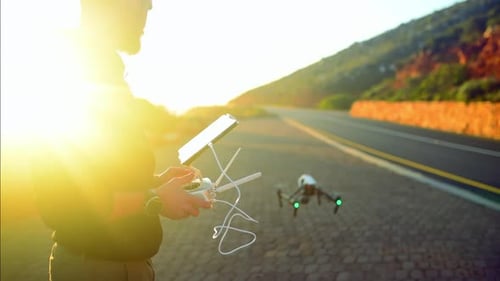 City, morning and man with drone and tablet for photography, aerial view and road on mountain