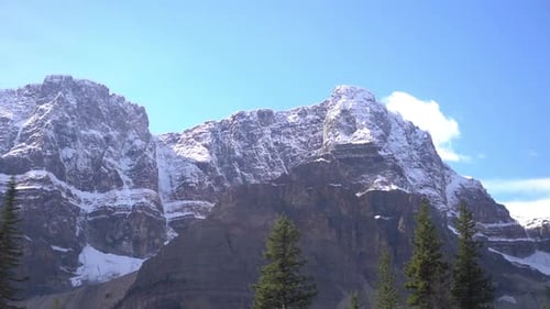 Driving by Snow Capped Peaks and Conifer Forest in Wilderness of Canada, Drivers POV