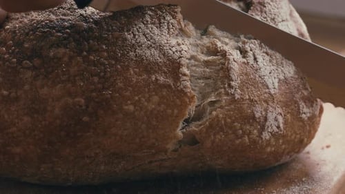 Slicing Freshly Baked Crusty Bread with Serrated Knife