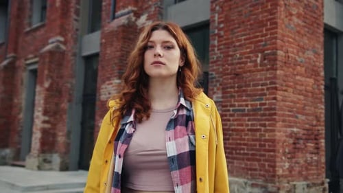 Beautiful Confident Young Woman Standing Near Building with Arms Folded Portrait of Serious Pretty