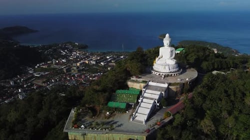 Tranquil Scenery of Shoreline in Thailand and Huge White Buddha Statue on Hilltop Filmed By Drone