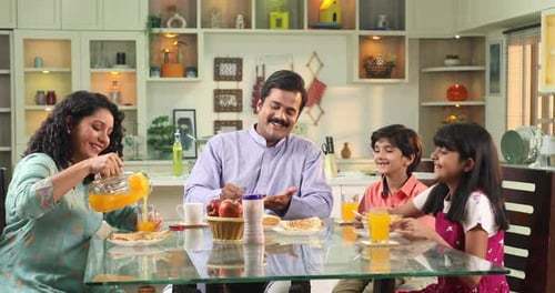 Happy Family Eating Breakfast At table