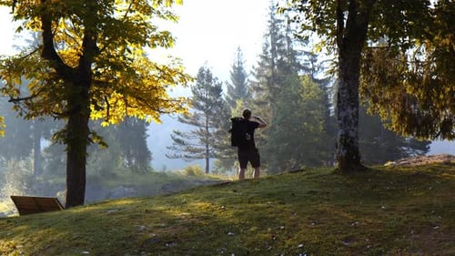 Tourist Hiker Traveler Hiking Standing Alone on Forest Mountain Edge Looking at Horizon, Caumasee Fl