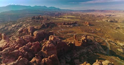 Rounded rocks of Arches National park in Utah, USA. Sunny panorama of mountainous valley