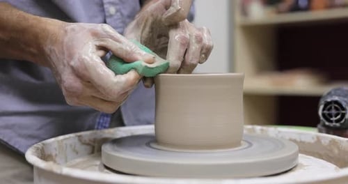 Male Hands Making Ceramic Cup on Pottery Wheel