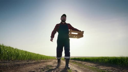 Fulllength Portrait of Professional Agronomist or Farmer in Farmland in Summer Cinematic Shot with