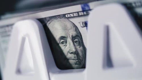 Close Up of Money Counting Machine Counting Hundred Dollar Banknotes