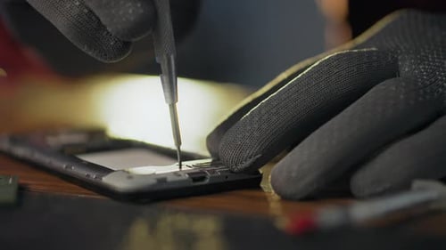 Scheme. A workshop worker equipped with tools holds a screwdriver in his hands in an electronic