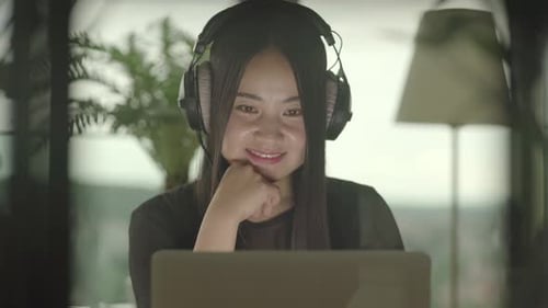 Young Asian Woman Using Laptop Computer Inside Apartment Home