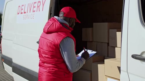 African American Delivery Man Delivering Parcel Box to Recipient Courier Checked Boxes Closes