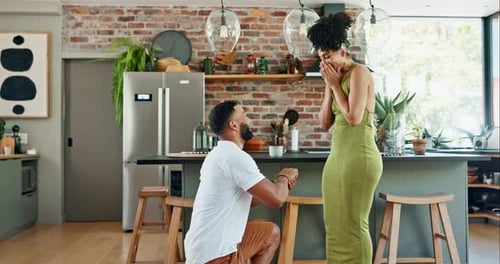 Man, surprise and proposal to woman with ring, engagement and commitment in relationship in living
