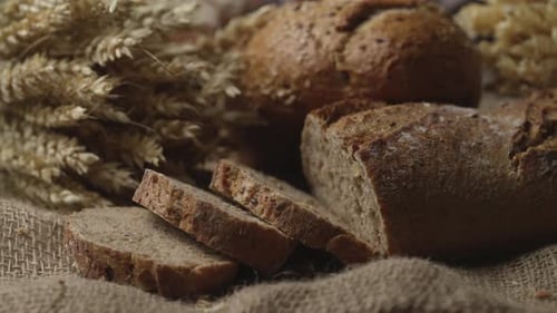Rustic Bread and Ears of Wheat on the Old Vintage Table