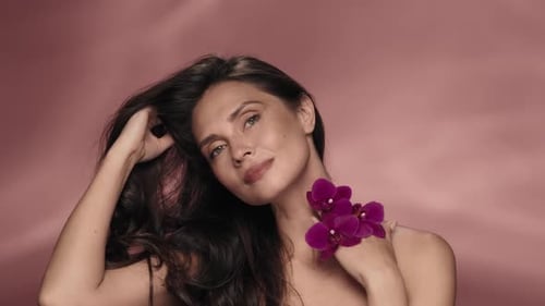 A Woman Touches Her Perfect Skin and Silky Hair Enjoying the Cosmetic Effect Portrait of a Woman