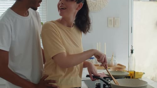 Diverse Spouses Kissing when Preparing Home Breakfast