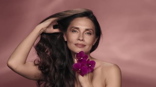 A Woman Touches Her Perfect Skin and Silky Hair Enjoying the Cosmetic Effect Portrait of a Woman
