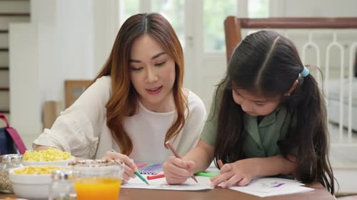 Two Asian Mother and Daughter Drawing with Colorful Pencil Markers Together at Home Family Woman