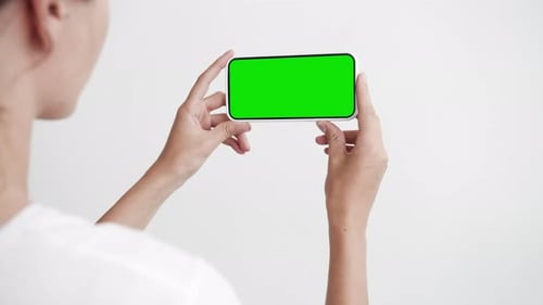 Young Adult Person Use Smart Phone with Green Screen Chroma Key Closeup