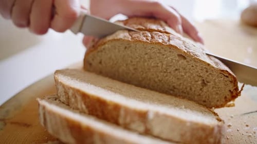 Slicing Fresh Bread in a Kitchen