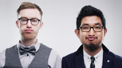 4k video footage of two male friends being silly against a studio background