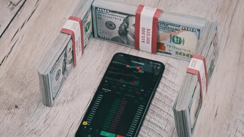 Cryptocurrency Prices on a Smartphone Screen on a Table with Dollars Ethereum