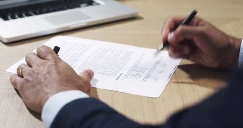 4k video footage of an unrecognizable businessman signing a contract in his office