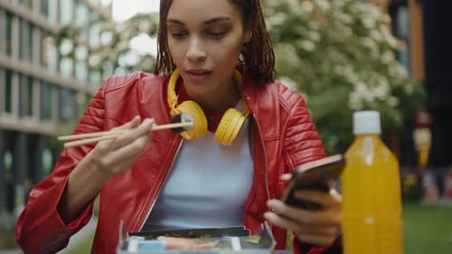 Young woman eating and spending time outside the office