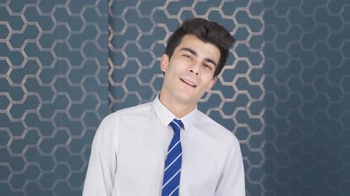 Happy and relaxed businessman looking at camera.