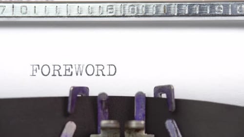 Foreword word close up being typing and centered on a sheet of paper on old vintage typewriter