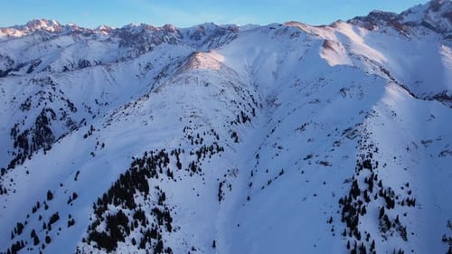 Epic Redorange Sunset in High Snowy Mountains