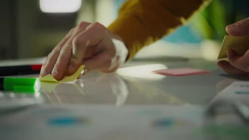 A young expert, while in work clothes, conducts a professional brainstorming audit in a meeting