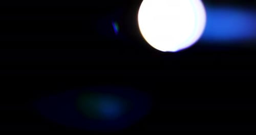 Beautiful, stunning light reflections and anamorphic blue streaks shot on black with high-end cinema