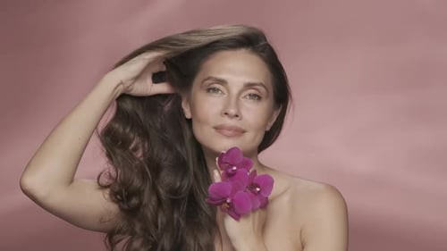 A Woman Touches Her Perfect Skin and Silky Hair Enjoying the Cosmetic Effect Portrait of a Woman