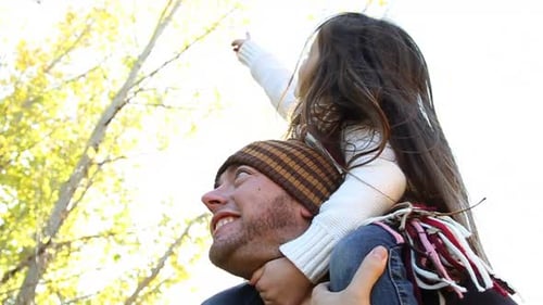 Happy family spending quality time together in their vibrant autumn backyard