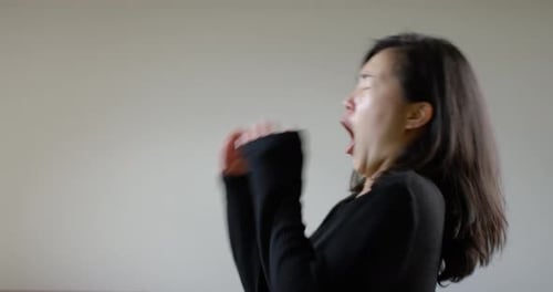 Asian Woman Sneezing During Corona Virus Pandemic From Side