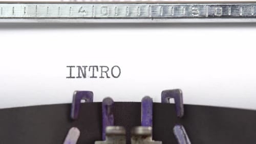 Intro word close up being typing and centered on a sheet of paper on old vintage typewriter mech