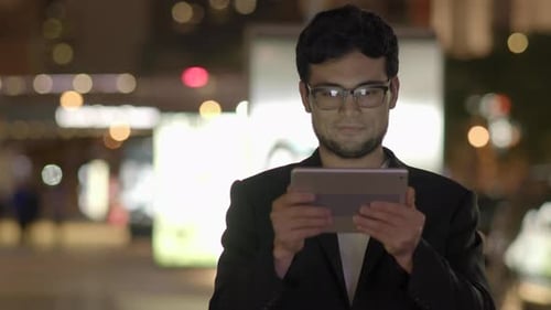 Modern City Lifestyle Portrait of Male Person Browsing the Web on Mobile Device