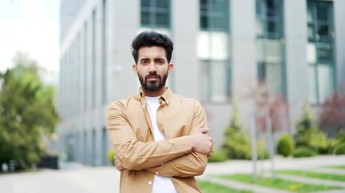 Portrait of a confident businessman standing outside looking into the camera. Handsome serious