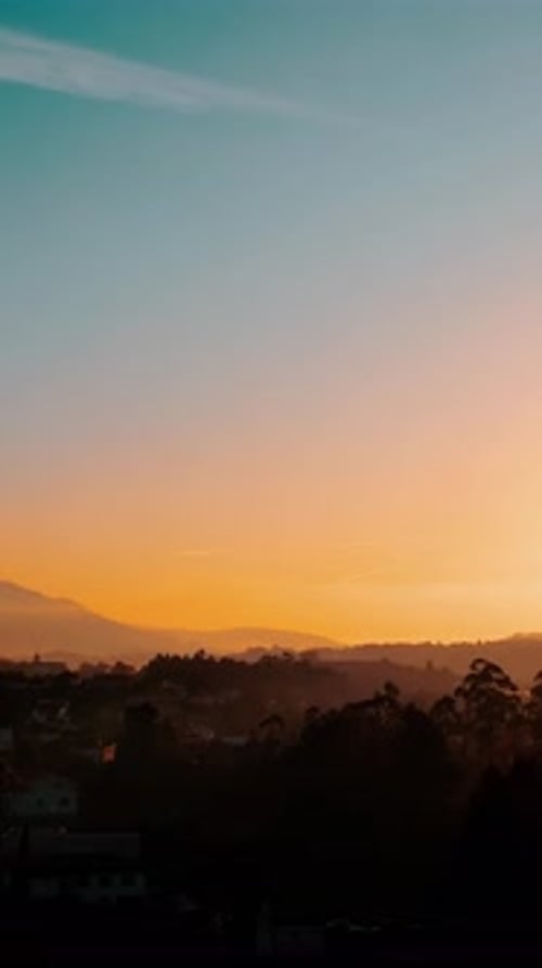 Sunset over the mountains - vertical background drone video