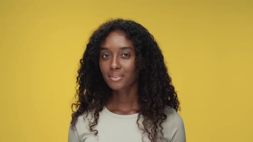 Portrait of Young African American Woman Looking at Camera and Smiling Happy