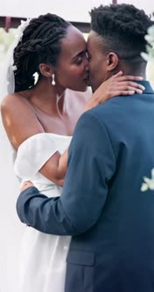 African man, kiss bride and wedding with smile, love and romance at event, celebration or ceremony