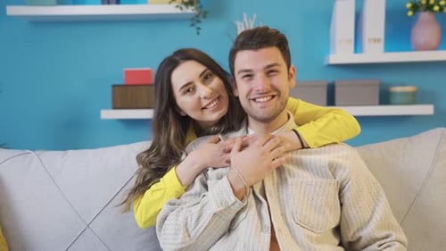 Portrait of a happy and cheerful young couple or two lovers at home.
