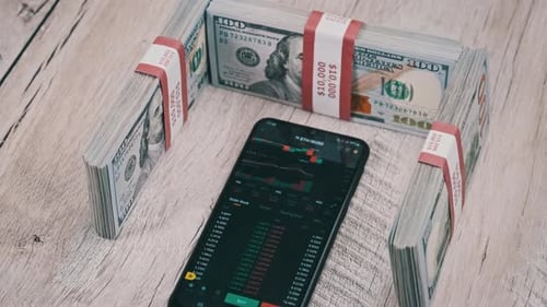 Cryptocurrency Prices on a Smartphone Screen on a Table with Dollars Ethereum