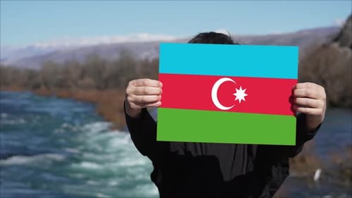 Person Holding Banner With Flag Of Azerbaijan