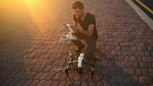 Street, morning and man with drone and tablet for photography, aerial view and cityscape